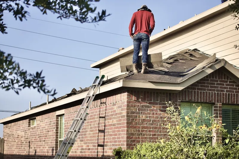 Professional roofer working on a residential roof in Harmony Heights